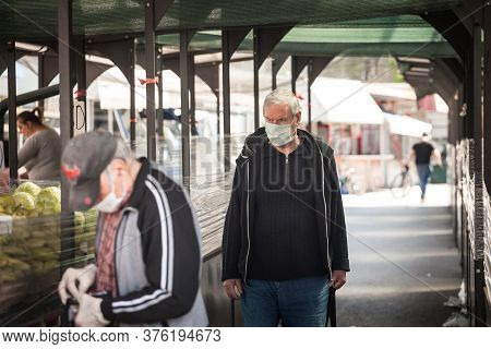 Belgrade, Serbia - April 28, 2020: Old Senior Men Wearing A Respiratory Face Masks Waiting In Queue 
