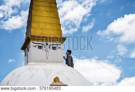 A Man On Background Of Clouds And Blue Sky, With A Pensive, Inspired Face And A Brush In His Hands, 