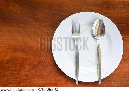 Empty Plate With Spoon Fork On Food Table Wooden Background / Empty Dinner Plate Dish , Top View