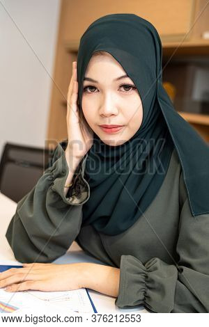 The Beautiful Woman Clasp Hands Under Her Chin,turn Face Dowm,praying,portrait Of Model Posing,blurr