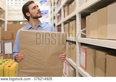 Portrait Of A Smiling Warehouse Keeper At Work.
