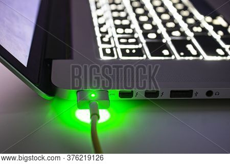 Calgary, Alberta. Canada. July 14, 2020. Close Up Macbook Computer Charging During The Night Side Vi