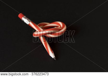 Flexible Pencil On A Dark Background. Selective Focus