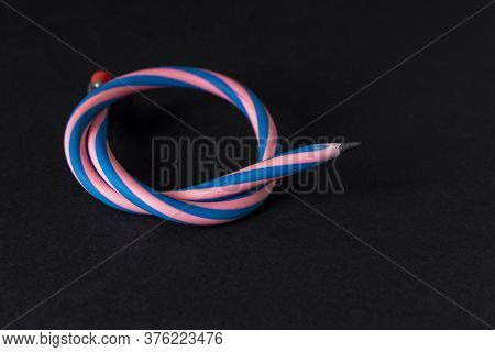 Flexible Pencil On A Dark Background. Selective Focus