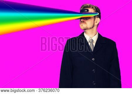 Businessman In A Formal Wear Wearing Virtual Reality Glasses Projecting Rainbow Rays From The Eyes -