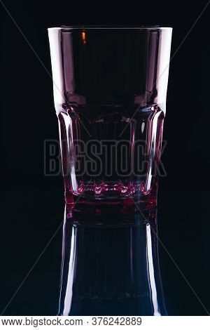Glass For Drinks On A Black Background. Transparent Empty Glass On Reflection Surface.