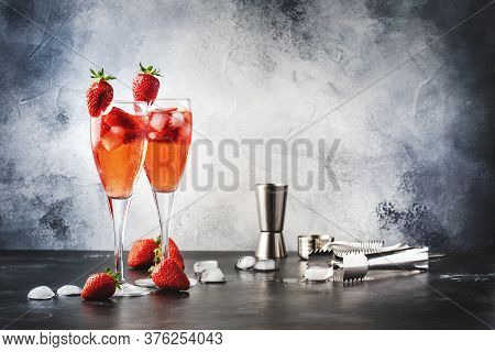 Rossini Italian Red Alcoholic Cocktail With Sparkling Wine, Strawberry Puree And Ice In Champagne Gl