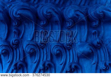 A Bas-relief Element In The Form Of Sea Waves At The Base Of The Buddha Statue In A Buddhist Temple.