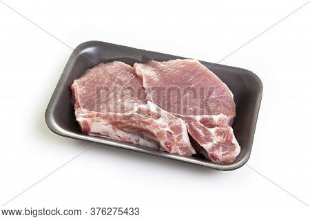 Raw pork steak in a package isolated on white background