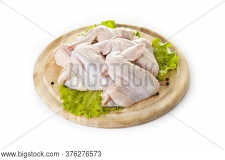 fresh raw chicken wings on the cutting board isolated on the white background