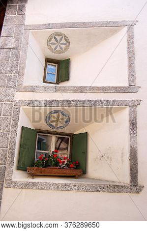 Two Small Old-fashioned Windows In The Ancient Village Of Guarda, Scuol Municipality, Engadin Valley