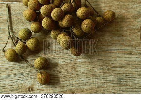 Longan Tropical Fruit In Branch On Wooden Table