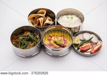Indian Lunch Box Or Tiffin - Spicy Ladies Finger, Dal Fry, Rice And Chapati
