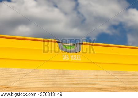Novosibirsk, Russia - 07.07.2020: Close-up Of A Yellow Hydro Level Der Maler With A Green Float Agai