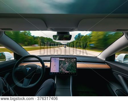 Raleigh, Nc Usa, May 09, 2020: Person Driving A New Tesla Model 3 On Autopilot