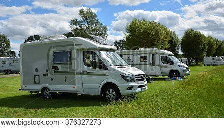 St Neots, Cambridgeshire, England - July 04, 2020: Two Large Camper Vans On Campsite.