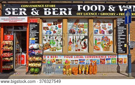 St Neots, Cambridgeshire, England - July 04, 2020:  Convenience Store Front With Advertising And Pro