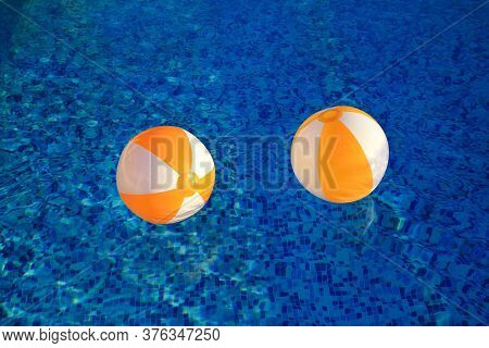 Two Rubber Air Yellow White Inflatable Balls And Toy For Swimming Pool In Transparent Blue Water. Mu