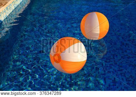 Two Rubber Air Yellow White Inflatable Balls And Toy For Swimming Pool In Transparent Blue Water. Mu