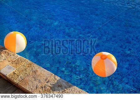 Two Rubber Air Yellow White Inflatable Balls And Toy For Swimming Pool In Transparent Blue Water. Mu