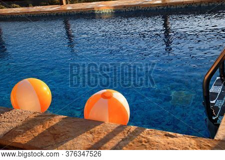 Two Rubber Air Yellow White Inflatable Balls And Toy For Swimming Pool In Transparent Blue Water. Mu