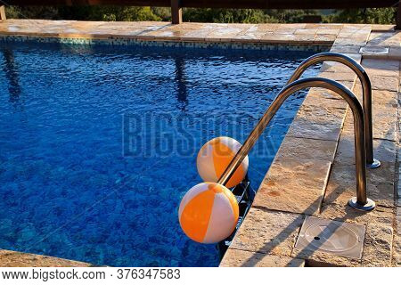 Two Rubber Air Yellow White Inflatable Balls And Toy For Swimming Pool In Transparent Blue Water. Mu