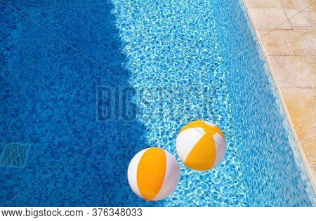 Two Rubber Air Yellow White Inflatable Balls And Toy For Swimming Pool In Transparent Blue Water. Mu