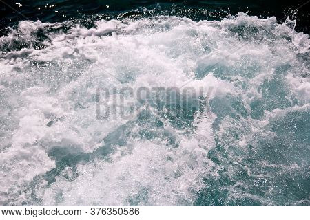 Turbulence Made By Foam Of Sea Water From A High-speed Yacht On Surface Of Sea. Blue Sea Waves With 