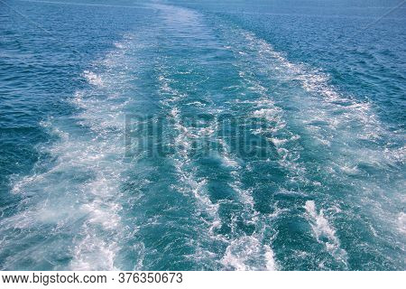 Turbulence Made By Foam Of Sea Water From A High-speed Yacht On Surface Of Sea. Blue Sea Waves With 