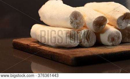 Edible Manioc Root (manihot Esculenta), Peeled And Frozen On Neutral Background