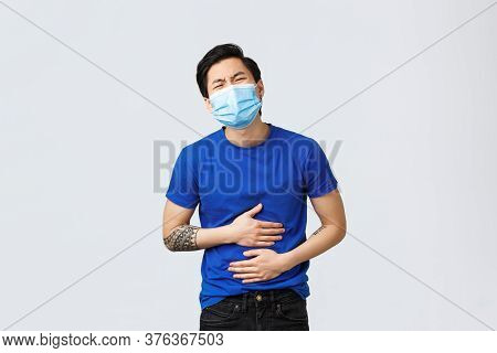Different Emotions, Social Distancing, Self-quarantine And Lifestyle Concept. Asian Guy Suffering Hu