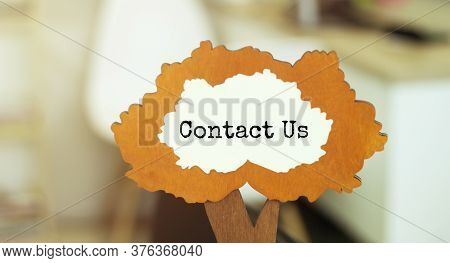 Figure Of A Tree With Text Contact Us Inside The Foliage. Business Concept