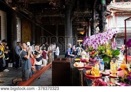 Taipei, Taiwan - October 20th, 2019: people praying in Lungshan temple at Taipei, Taiwan