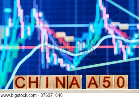 China A50 Index Concept. Wooden Blocks With China A50 Inscription With Chart On Background