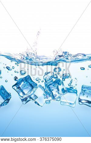 Many Ice Cubes Fall Into The Blue Water, Causing The Water To Spread, Creating Beautiful Bubbles.