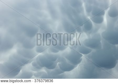 Menacing Mammatus Clouds Before The Storm, Stormy Sky, Climate Change And Unpredictable Terrifying M