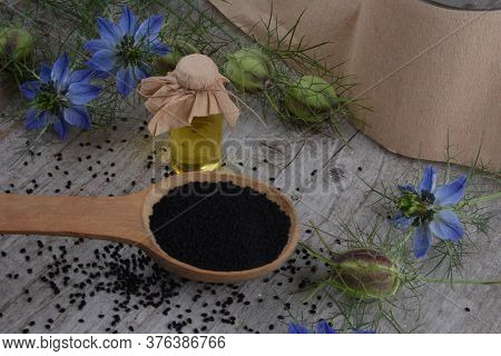 Black Cumin (nigella Sativa Or Kalonji) Seeds In Heart-shaped Bowl On Wooden Background