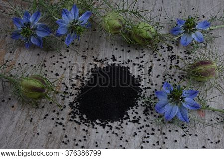 Black Cumin (nigella Sativa Or Kalonji) Seeds In Heart-shaped Bowl On Wooden Background