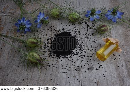 Black Cumin (nigella Sativa Or Kalonji) Seeds In Heart-shaped Bowl On Wooden Background
