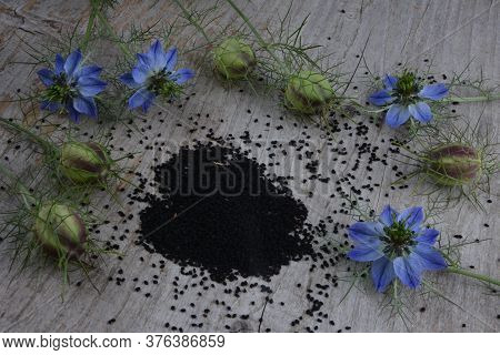 Black Cumin (nigella Sativa Or Kalonji) Seeds In Heart-shaped Bowl On Wooden Background