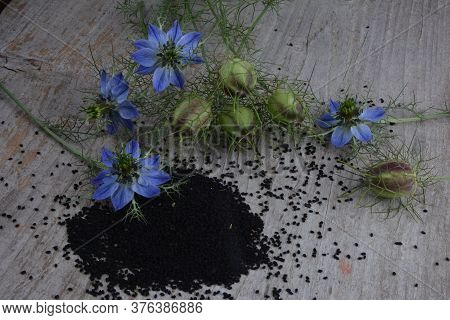 Black Cumin (nigella Sativa Or Kalonji) Seeds In Heart-shaped Bowl On Wooden Background