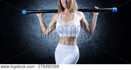 Charming Girl Posing With A Bodybar. The Concept Of Fitness, Bodybuilding And Healthy Lifestyle.