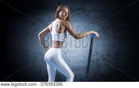 Charming Girl Posing With A Bodybar. The Concept Of Fitness, Bodybuilding And Healthy Lifestyle.