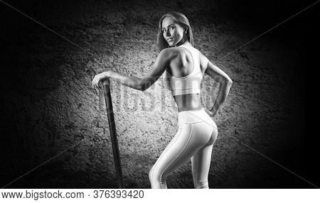 Charming Girl Posing With A Bodybar. The Concept Of Fitness, Bodybuilding And Healthy Lifestyle.