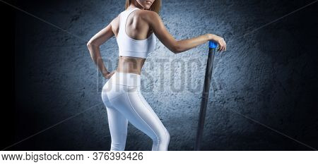 Charming Girl Posing With A Bodybar. The Concept Of Fitness, Bodybuilding And Healthy Lifestyle.