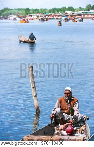 Srinagar, Jammu, Kashmir, India - August 01, 2020 : Lifestyle Of Local Indian Old Man Relaxing And S