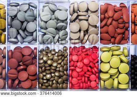 Variety Of Sample Medicine Pill Product Shape And Color Are Display On A Transparent Plastic Box To 