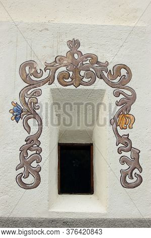 Guarda, Switzerland - Aug 14, 2009: Small Window With Fresco On White Wall In The Ancient Village Of