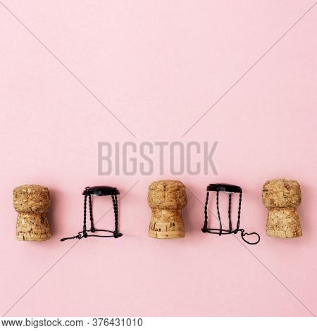 Creative Layout With Corks And Muselets From Champagne And Heart On Pink Paper With Copy Space. Back