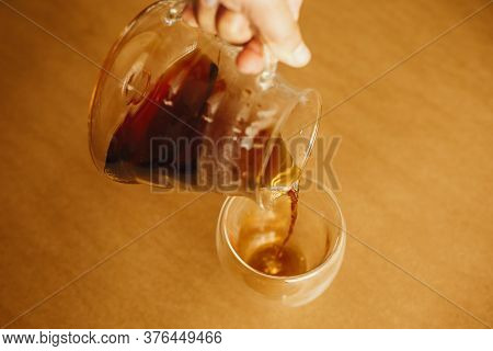 Brewing Alternative Coffee, V60. Pouring Fresh Aromatic Coffee From Glass Kettle In Cup On Brown Bac